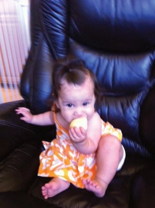 Bradley baby gnawing on an apple 