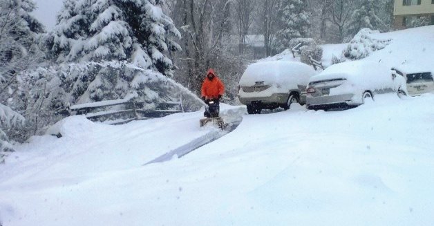 Matt Dailey HIS of Stone's hearing Aid Service protecting his hearing while snow blowing 
