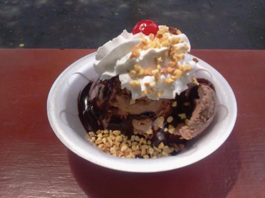Our Proud Mary Peanut Buttercup Sundae is warm brownies topped with peanut buttercup ice cream, hot fudge, whipped cream, nuts and a cherry!
