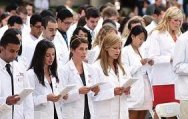 Class of new doctors reading the Hypocratic  oath