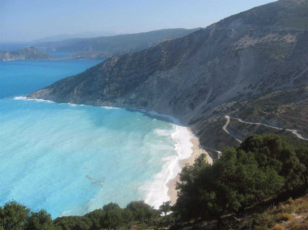Myrtos Beach, Kefalonia Greece is one of the best beaches with a beautiful sunset.