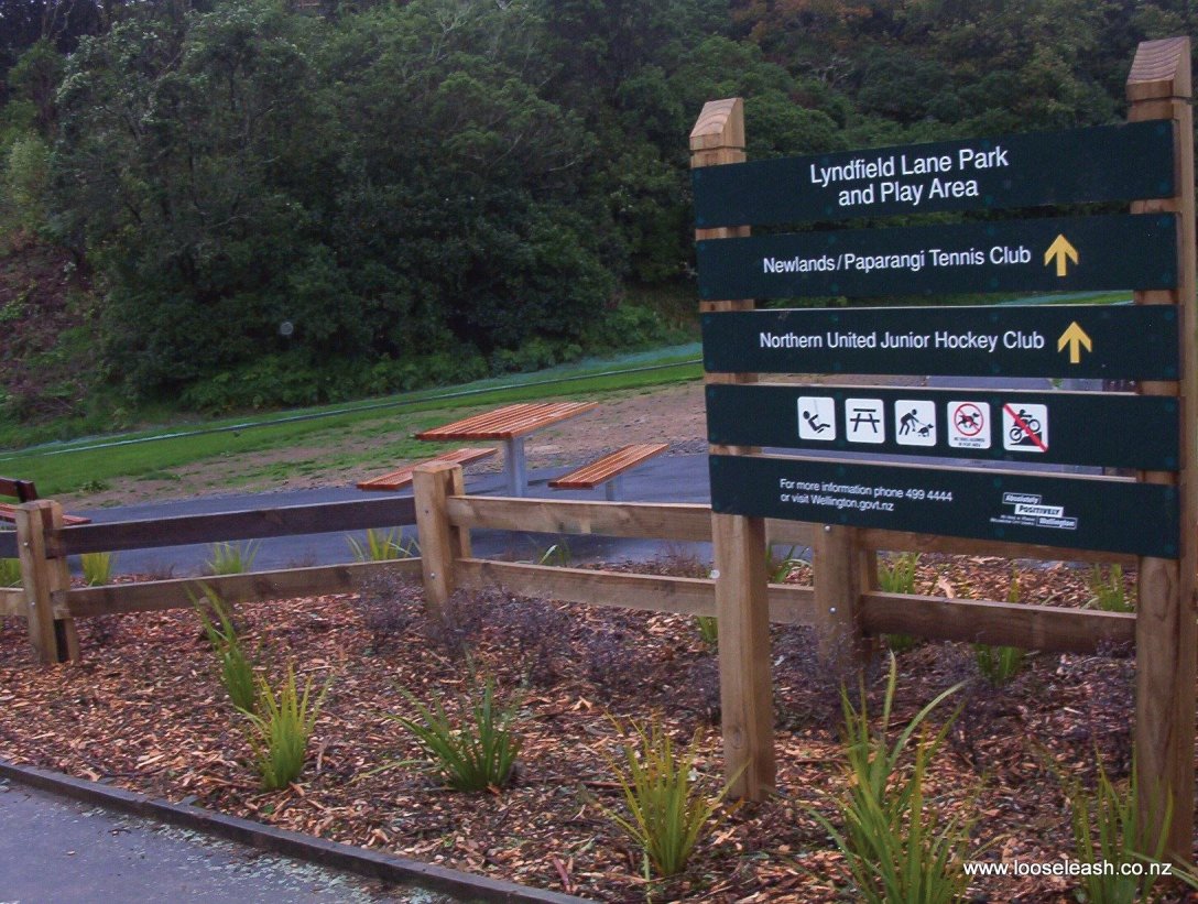 Lyndfield Lane Park Sign and Picknic Tables near entrance, Bush walk up the hill in the background, by Loose Leash Dog Walking Service Newlands Johnsonvile Wellington