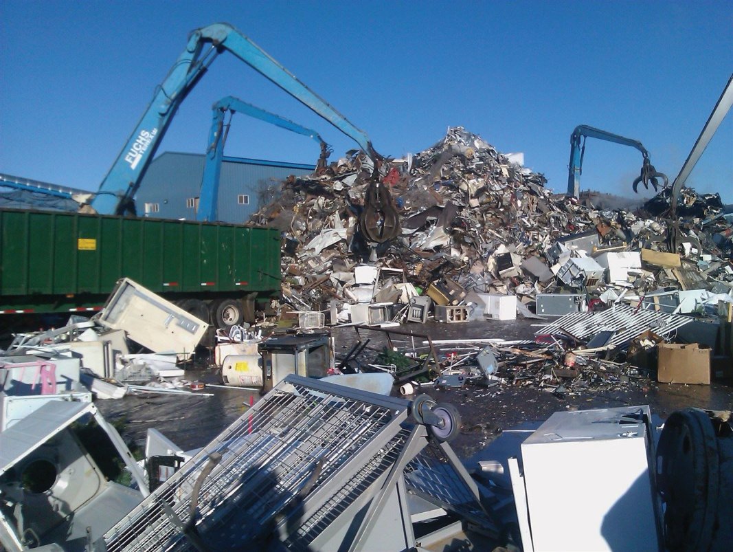 Appliances and scrap metal being crushed and shredded 